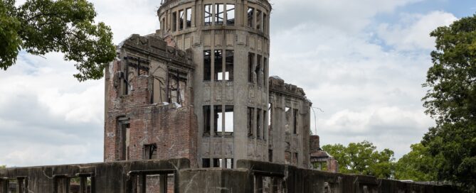 the gray shell of a dome building that has been bombed out